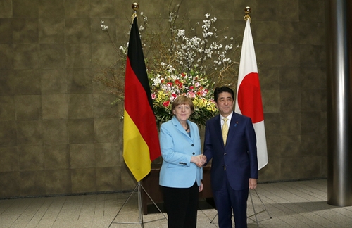 3月9日，在日本東京首相官邸，日本首相安倍晉三（右）歡迎到訪的德國總理默克爾。新華社發(fā)