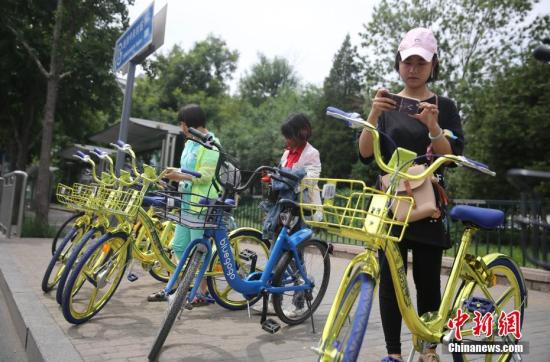 資料圖 6月8日，民眾在北京街頭掃碼租用一款“土豪金”色的共享單車。 <a target='_blank' href='http://www.chinanews.com/'>中新社</a>記者 楊可佳 攝