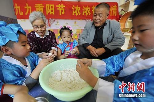 資料圖：小朋友與老人共做重陽(yáng)糕。 孟德龍 攝